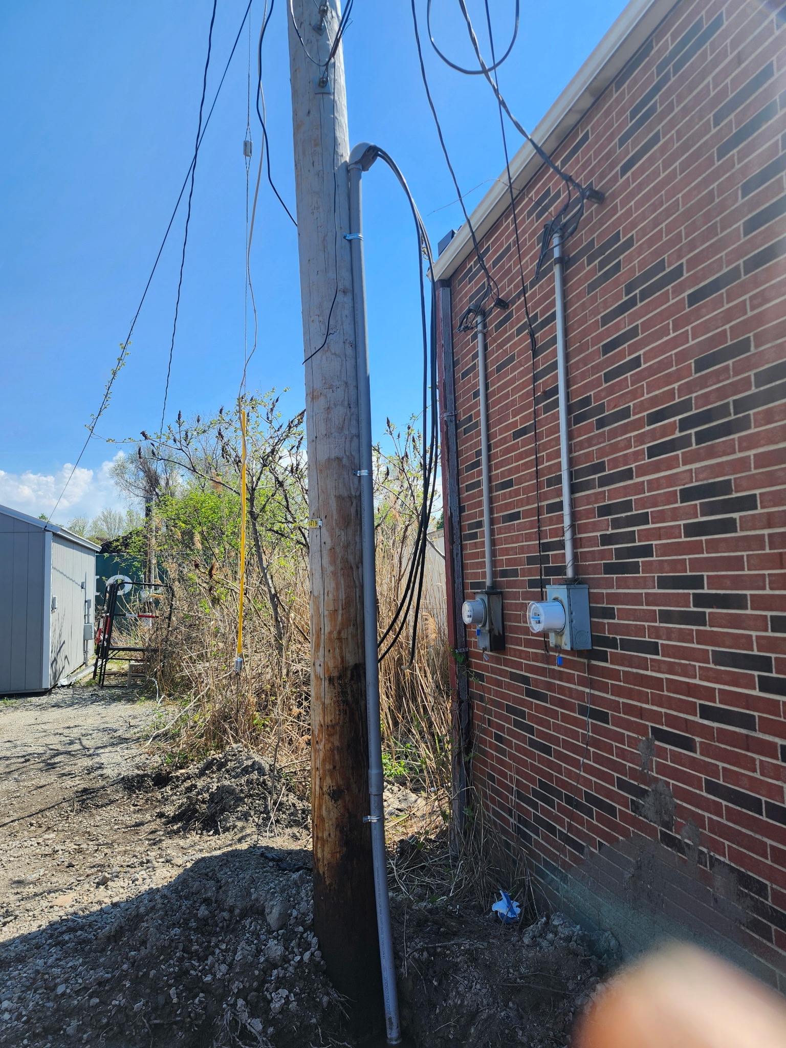 Electrical service entrance running from the utility pole to the building